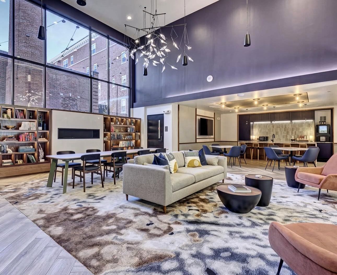 A living room with a couch , chairs , tables and a fireplace.