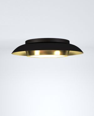 A black and gold ceiling light is sitting on a white surface.