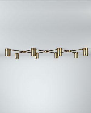 A row of brass candle holders on a white wall