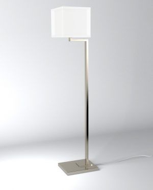 A floor lamp with a white shade is sitting on a white surface.