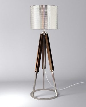 A tripod lamp with a white shade on a white background.
