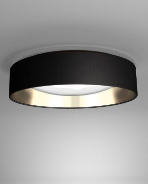 A black ceiling light with a gold rim is hanging from the ceiling.