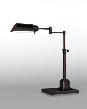 A black desk lamp is sitting on a white surface.