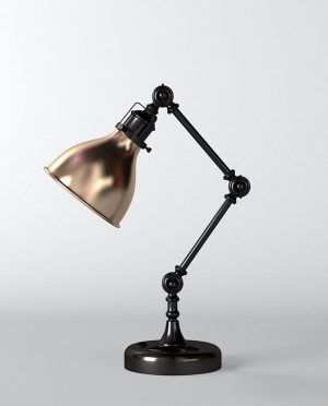 A black desk lamp with a gold shade on a white background.