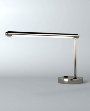 A silver table lamp is sitting on a white surface.
