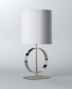 A table lamp with a white shade is sitting on a white surface.