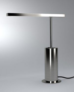 A stainless steel table lamp is sitting on a white surface.
