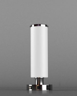 A white table lamp with a chrome base is sitting on a table.