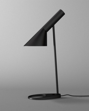 A black lamp is sitting on a gray surface
