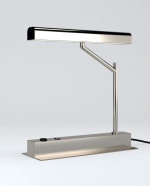 A stainless steel table lamp is sitting on a white surface.