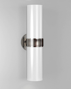 A white wall light with a chrome band around it is on a white wall.