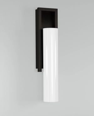A black and white wall light with a white cylinder on a white wall.