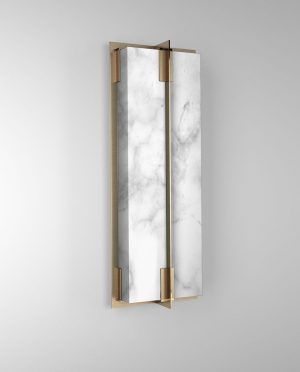 A marble wall light with a brass frame on a white wall.