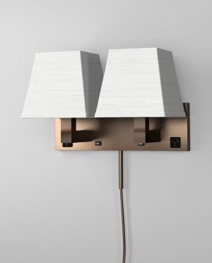 A wall light with two white shades attached to it