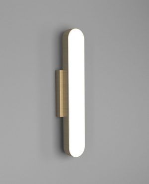A brass wall light with a white light on a gray wall.
