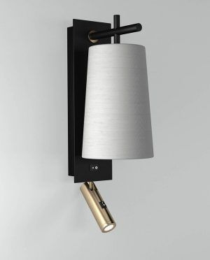 A black and gold wall light with a white shade