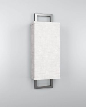 A wall light with a white shade is hanging on a white wall.