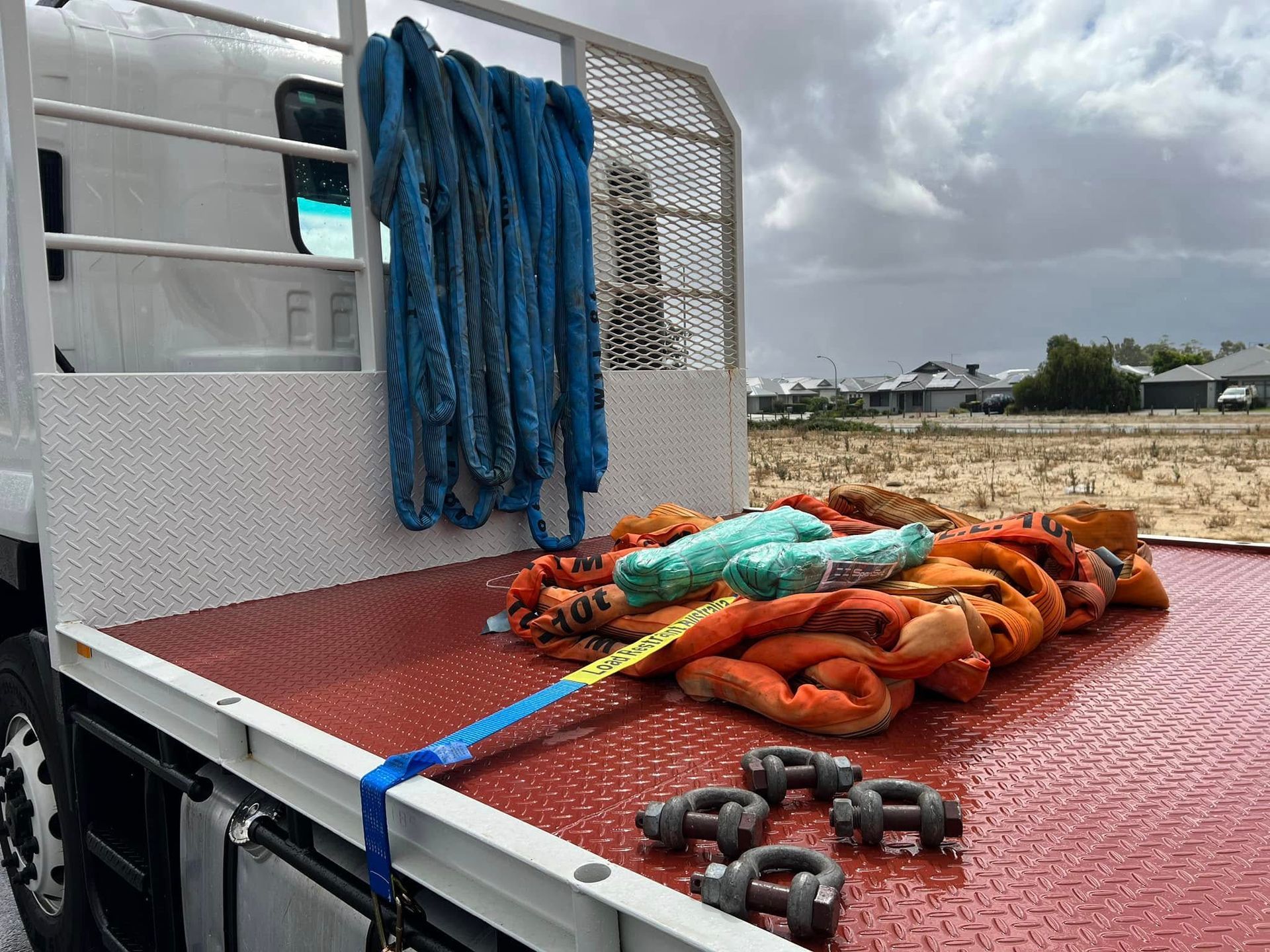 A truck with ropes and chains on the back of it.