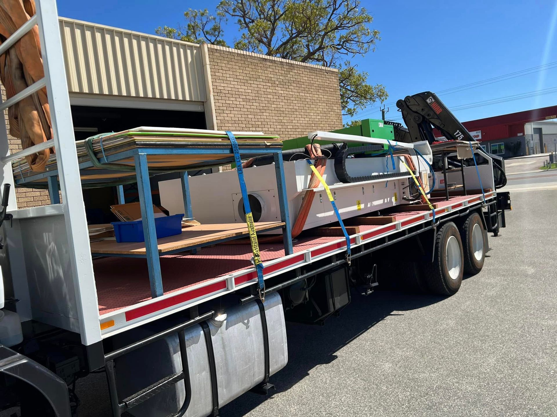 A large truck is carrying a lot of cargo on the back of it.