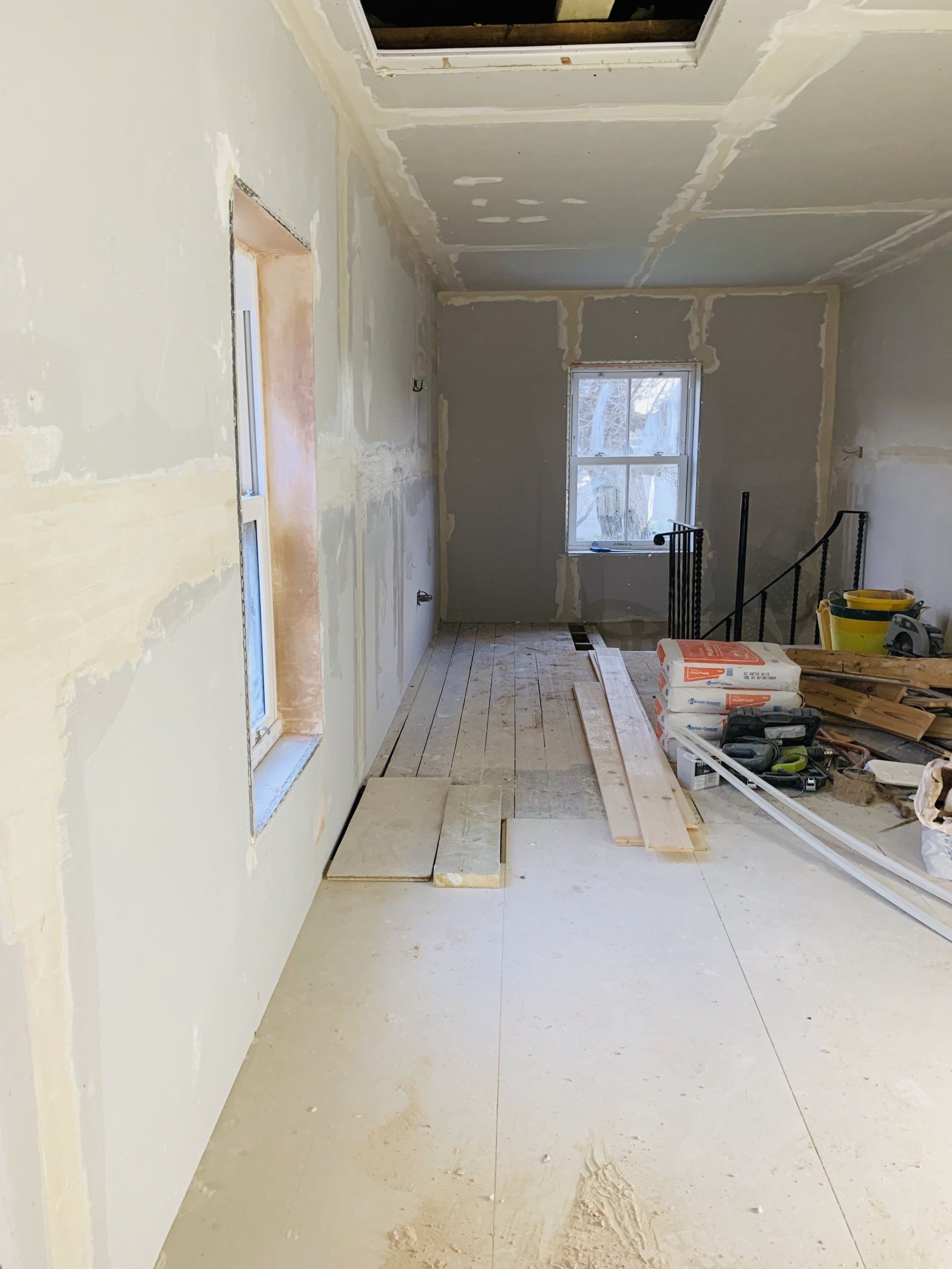 Image showing recent project - Full re-plastering in process, with other trades working in coordination with each other