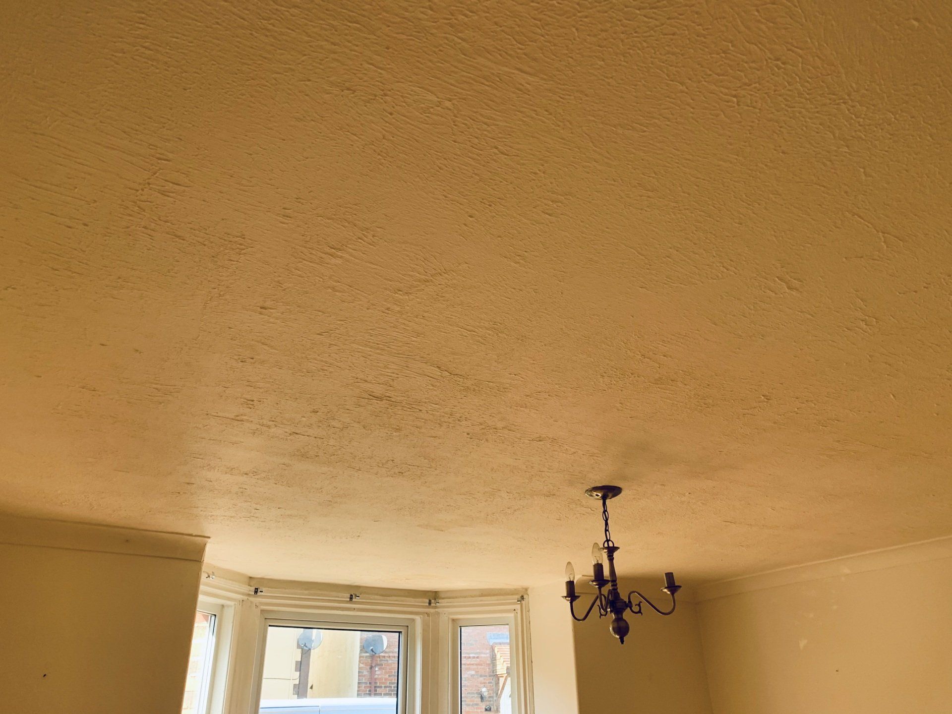 Image of previous project - Artex covering of ceiling removed and area re-plastered ready for decorating