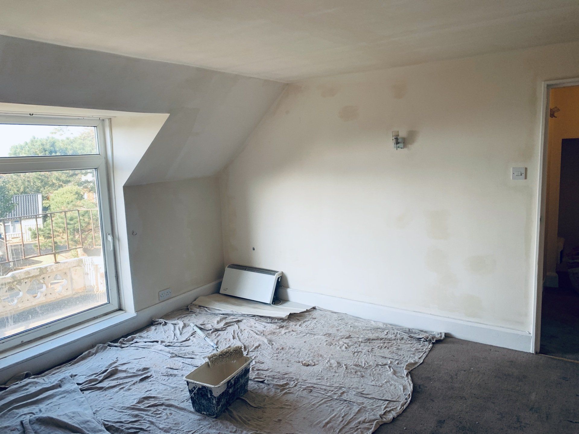 Image of completed & drying plastering in  a room in residential property