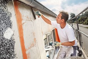 Image of man carrying out rendering on external walls of residential property