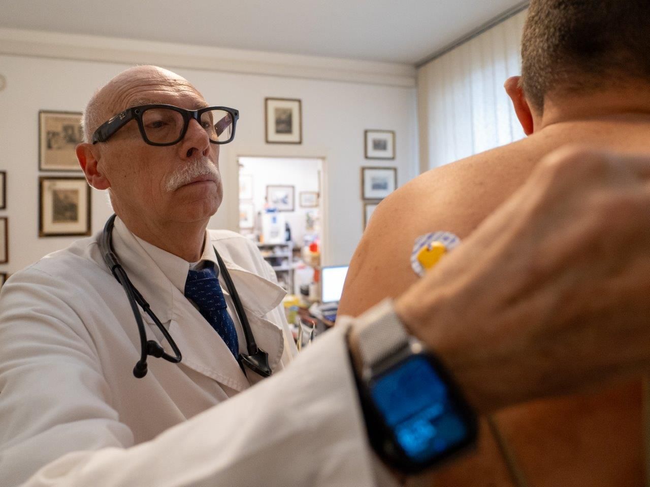 Un uomo sta ricevendo un elettrocardiogramma da un'infermiera.