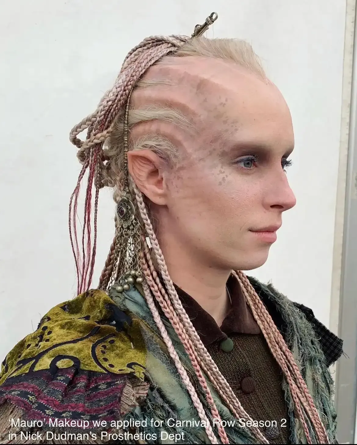 A prosthetic makeup design for Carnival Row, featuring ridges on the scalp, pointed ears, and light braids against skin.