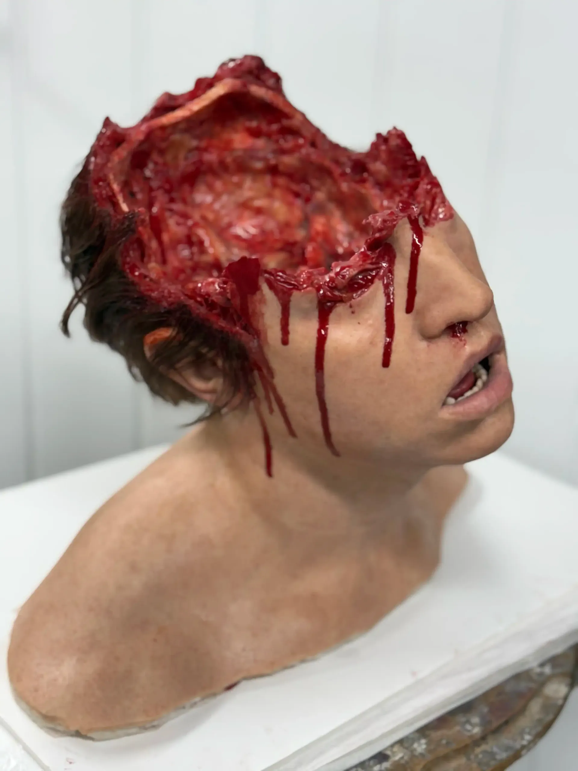 Charred meat with visible red and black areas, next to a small, clear container.