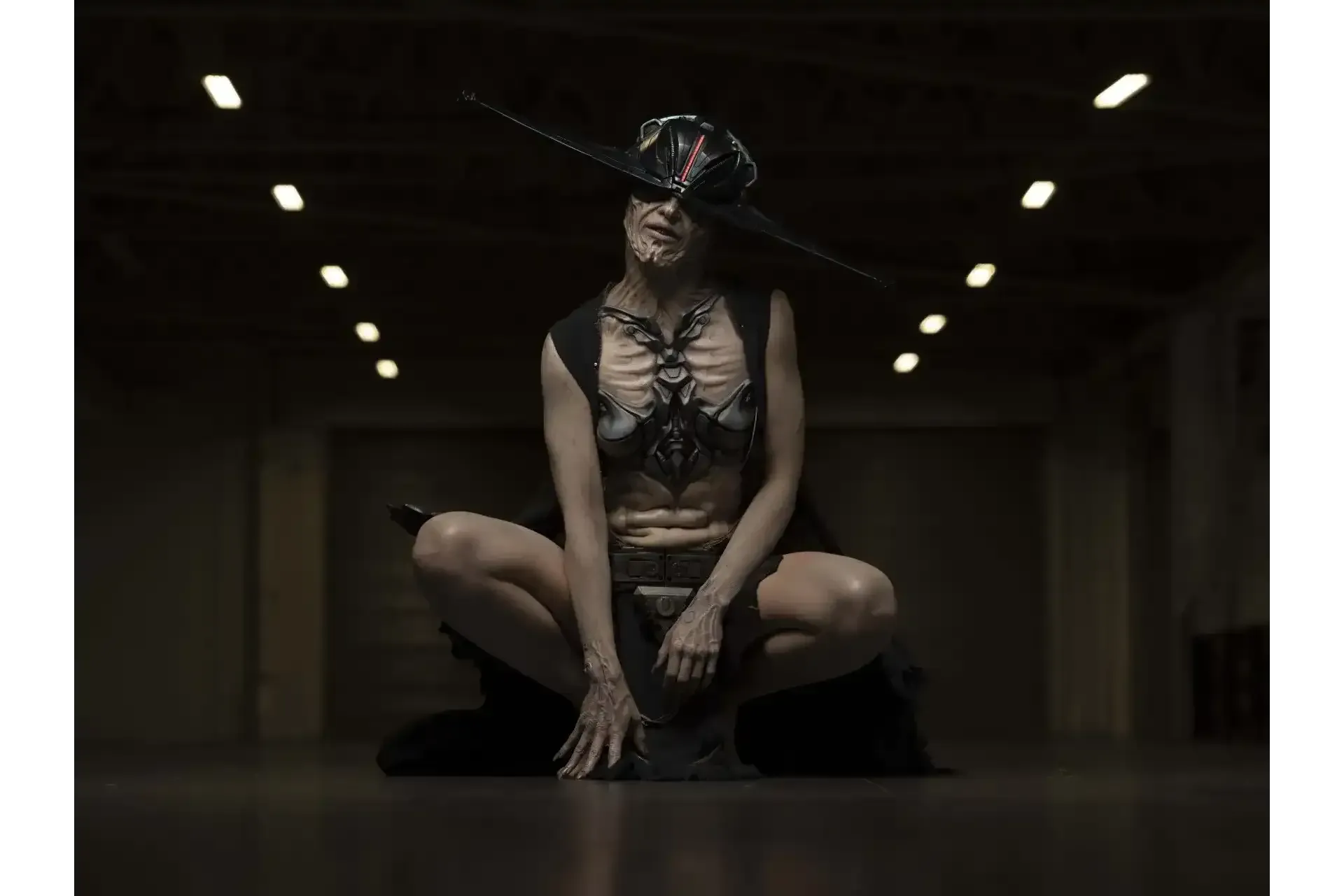 The Drexis on-set in full technologically integrated prosthetics, with sci-fi sightless hard edged headpiece design in long robes. 