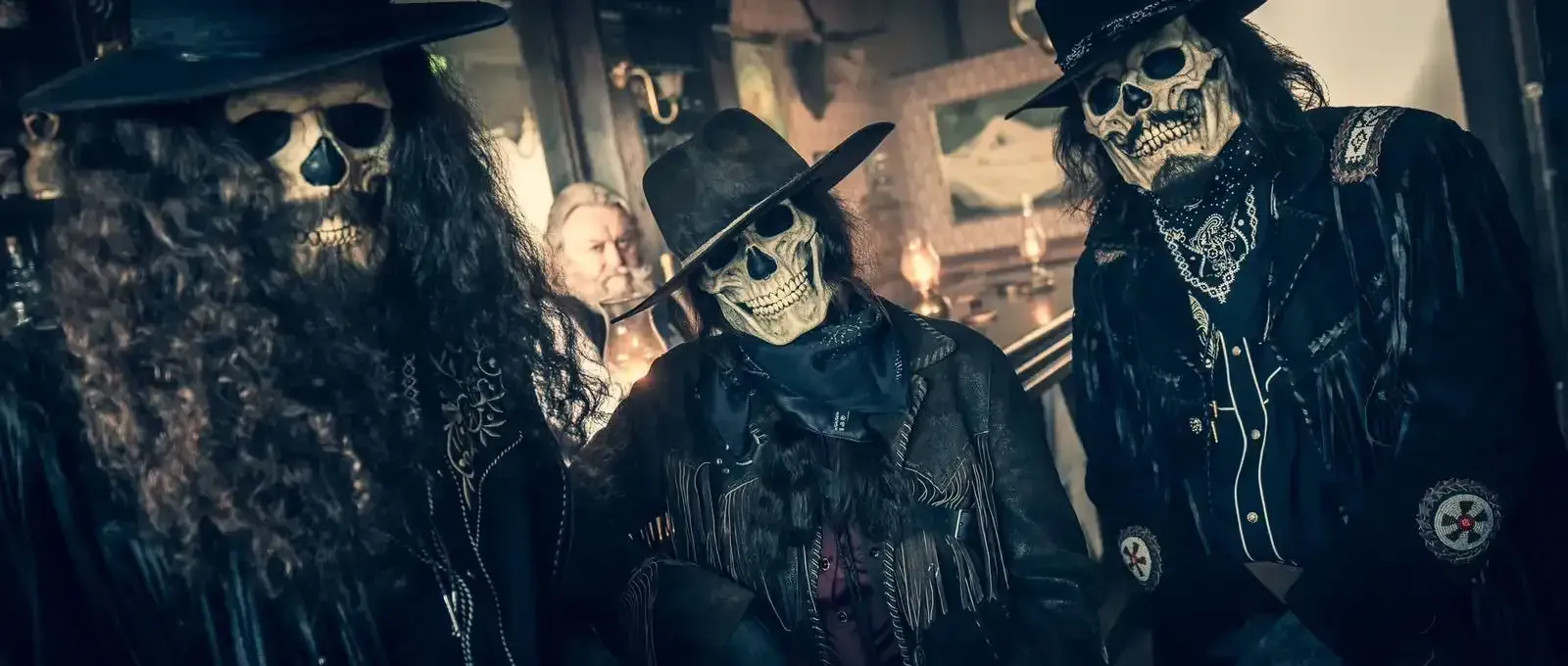 Three musicians play instruments in front of a burning building at night.