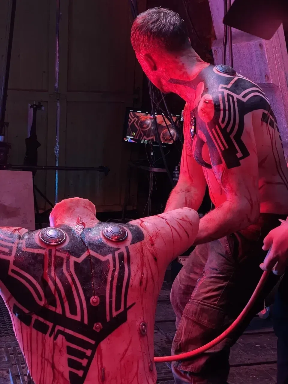 Alien bust with detailed head and armored chest, set in a workshop.