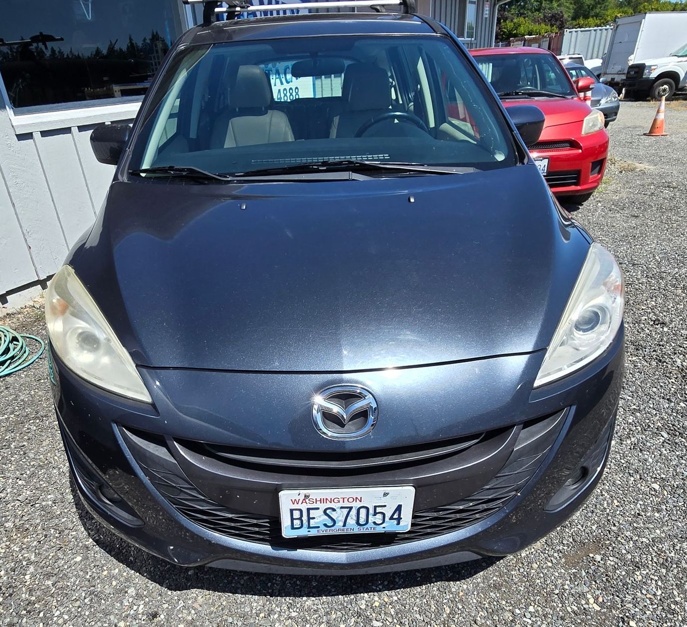 A black car with a license plate that says bes7054