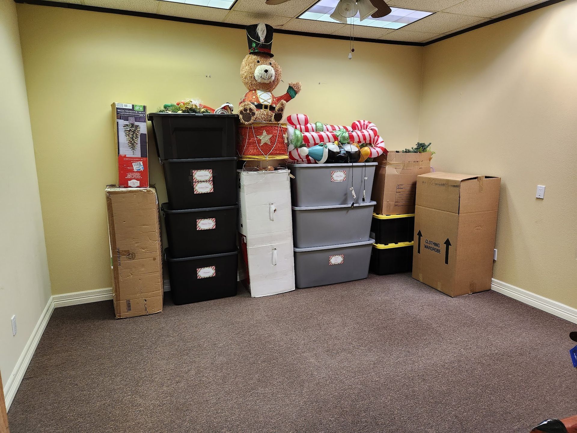 A room filled with lots of boxes and a teddy bear.