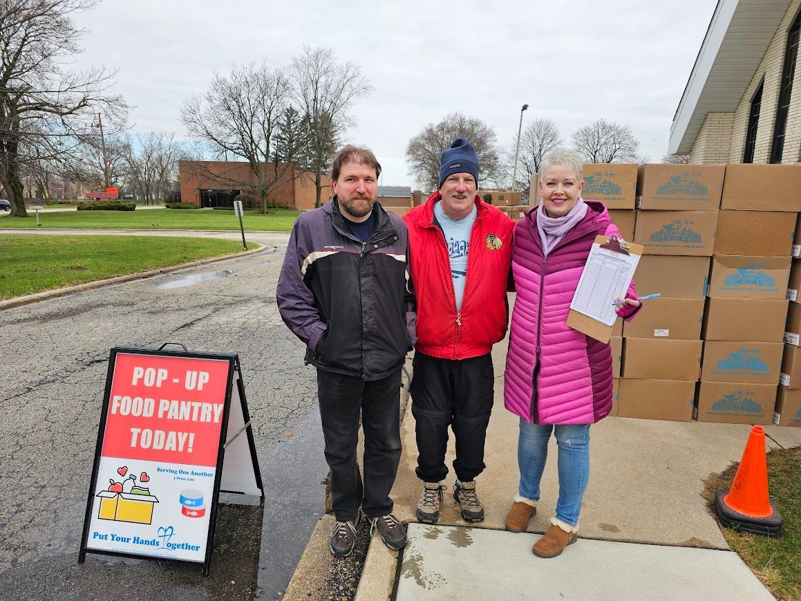 Three people are standing in front of a sign that says pop up from pantry today.