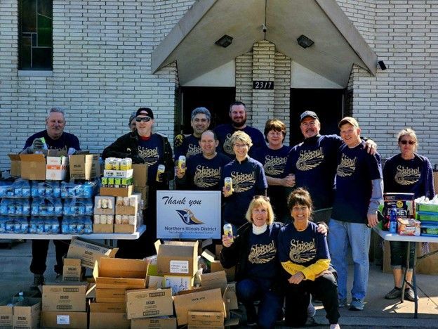 A group of people posing for a picture with a sign that says thank you