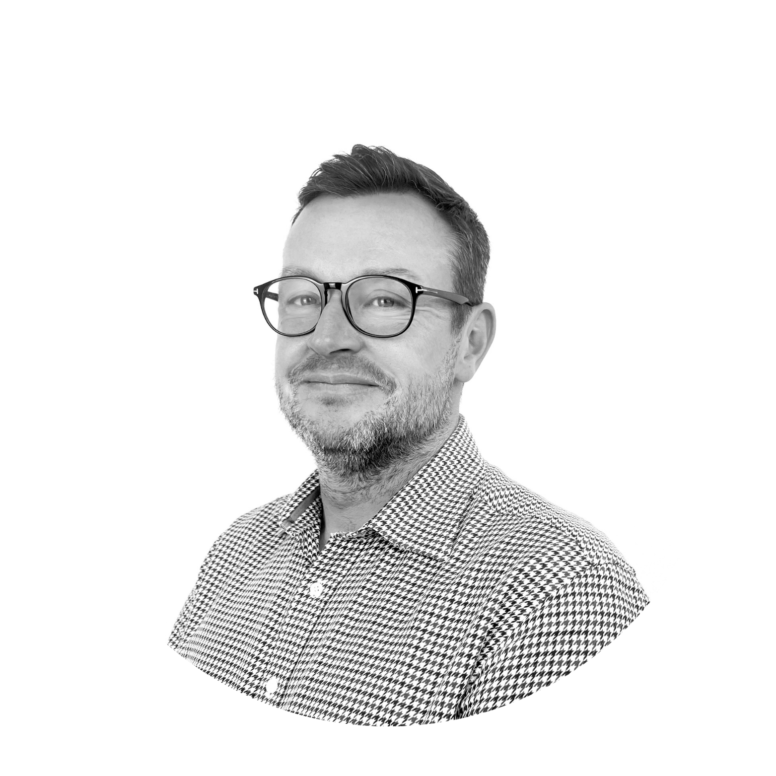 A black and white photo of a man wearing glasses and a plaid shirt.
