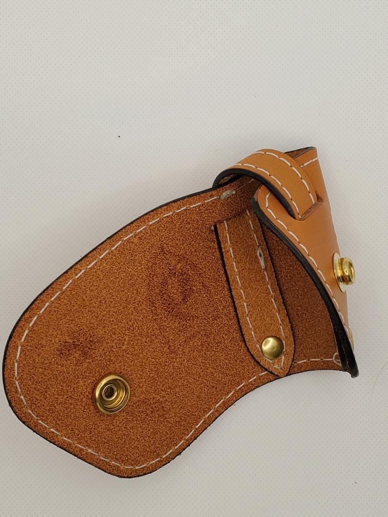 Tan leather inner with white stitching, brass snap and loop closure.