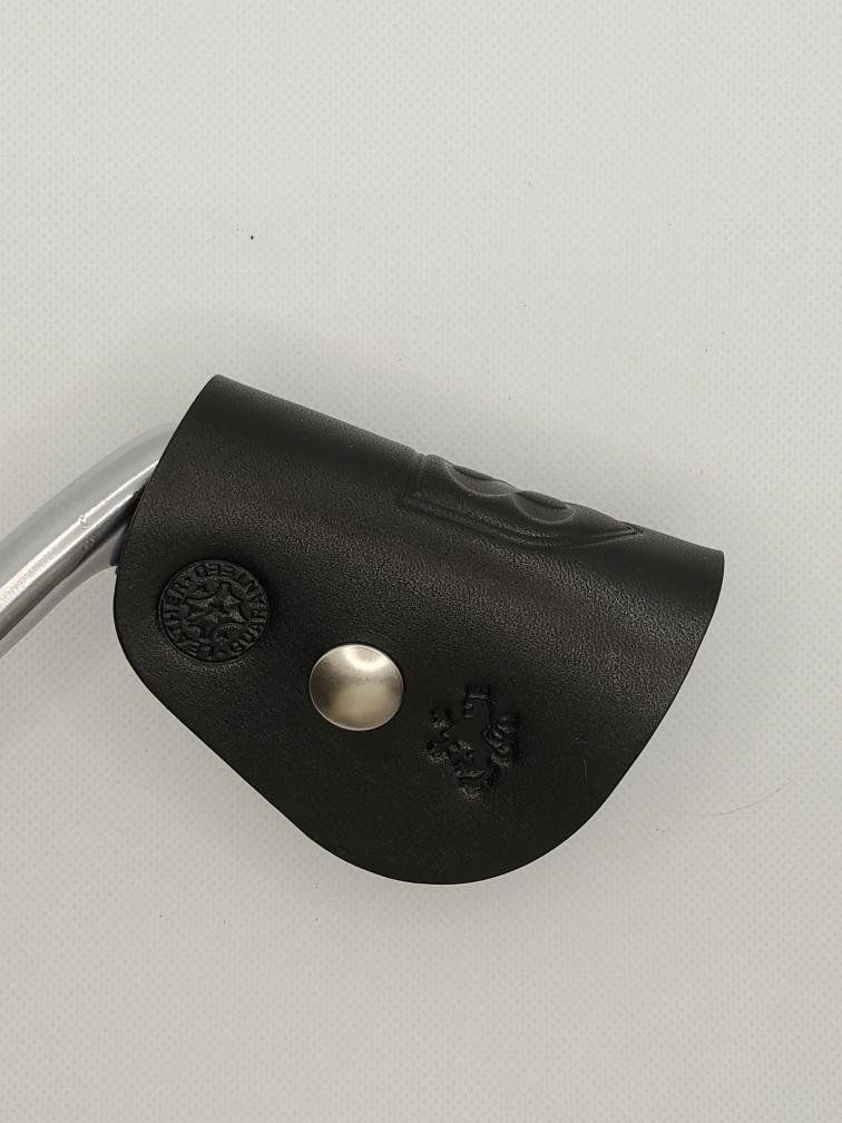 Black leather Player series ClubShield on a club head.