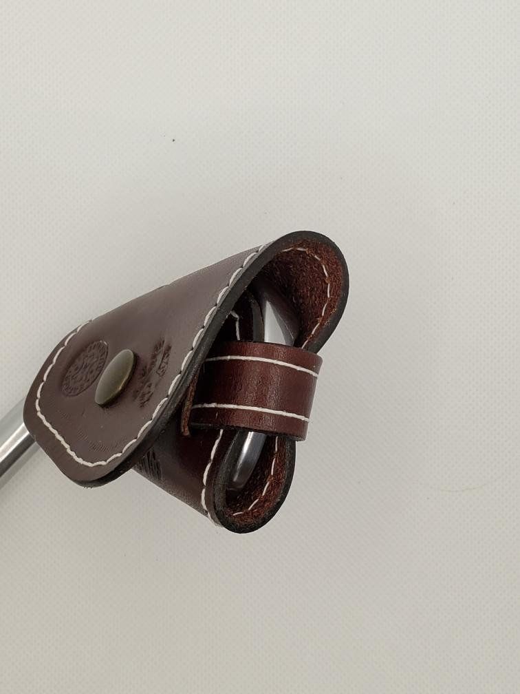 Dark burgundy leather golf club head cover with white stitching, snapped shut.