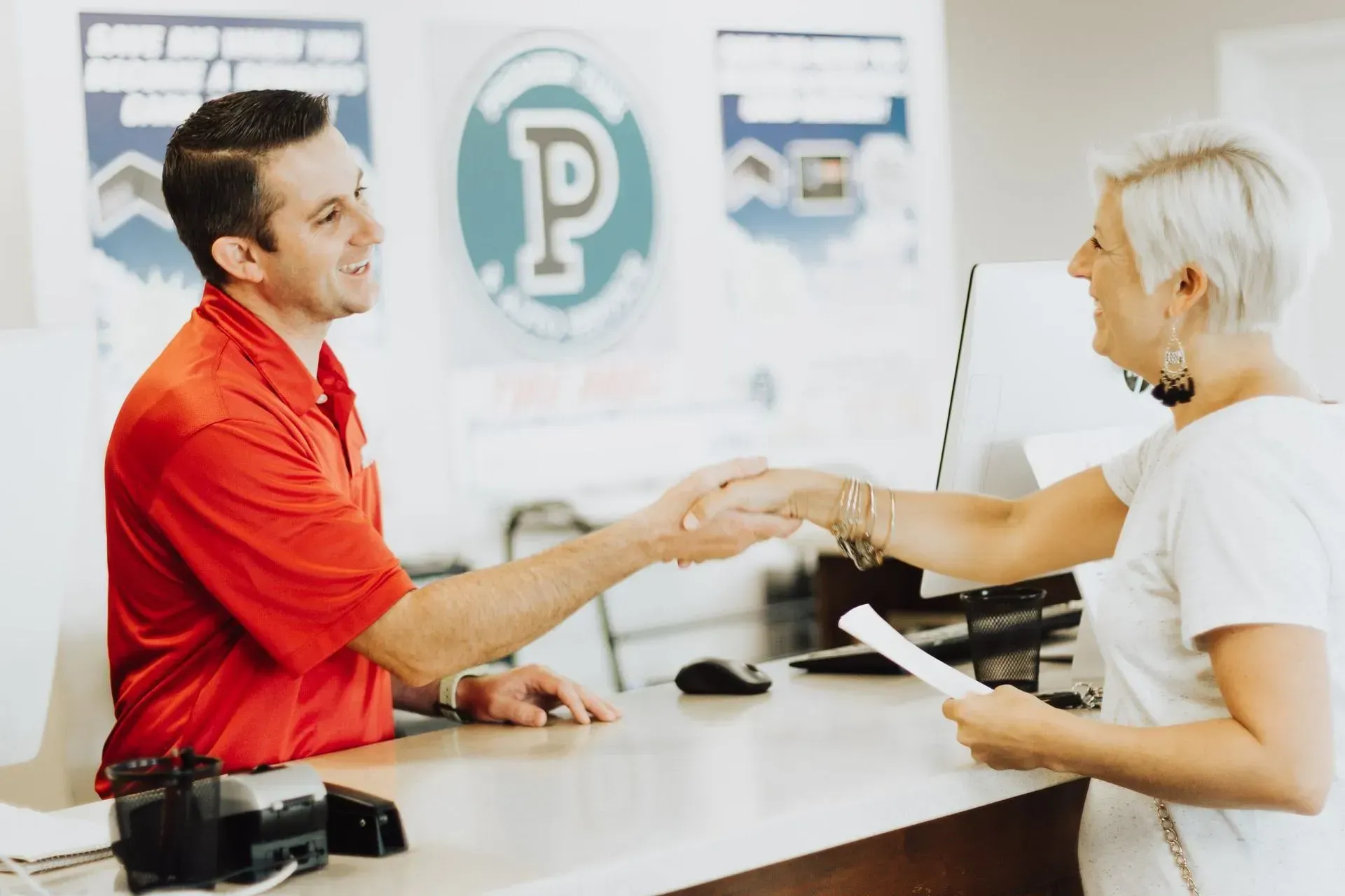 A black and yellow logo for synchrony car care