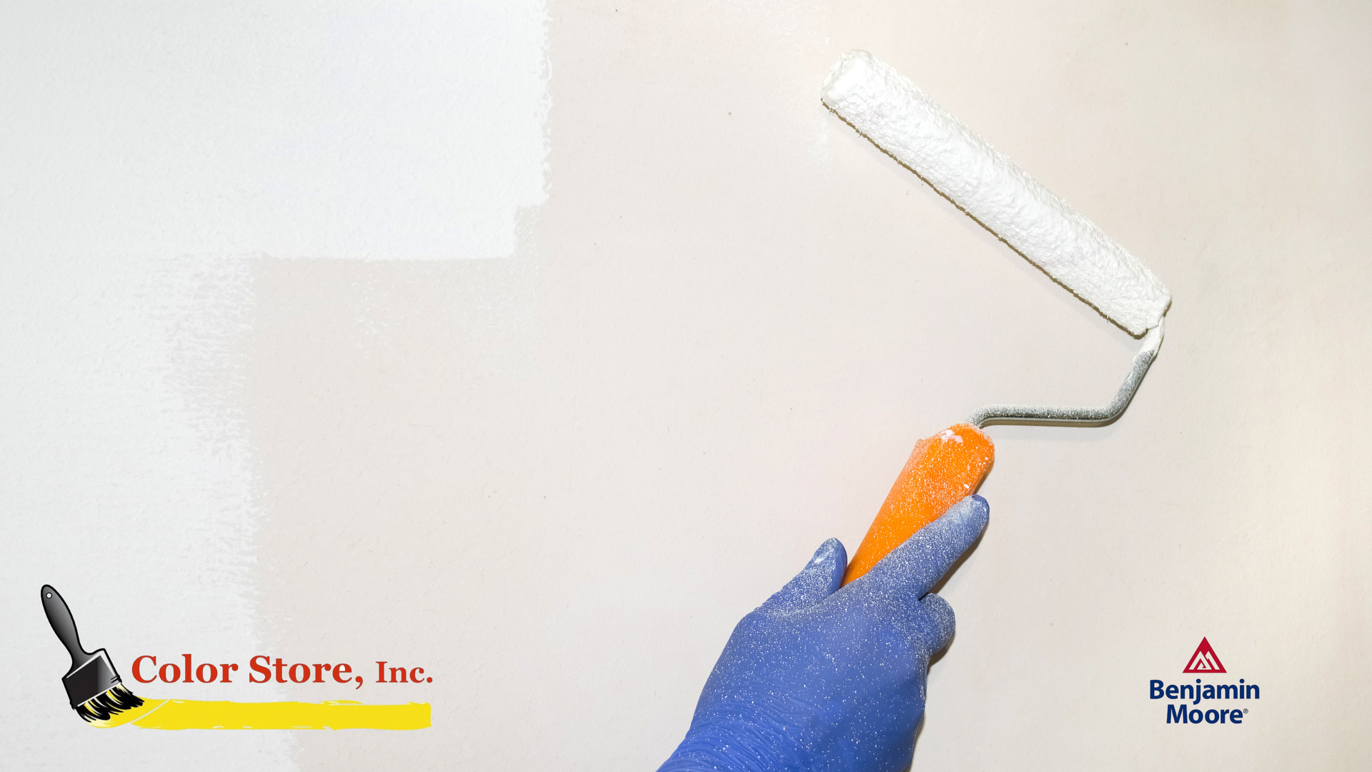 A gloved hand painting the wall with a paint roller to prevent paint streaks. 