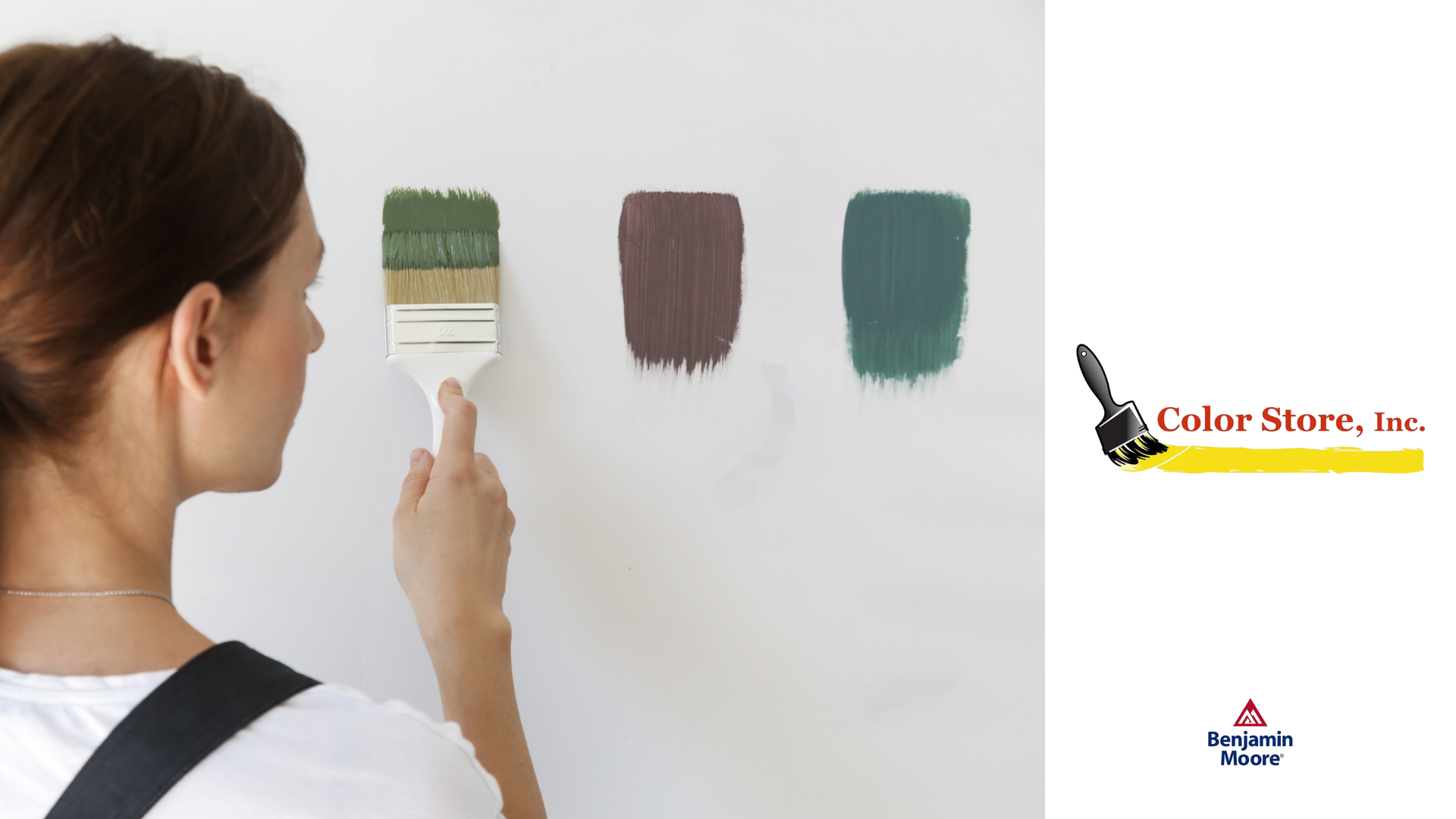 Woman painting wall with different Benjamin Moore paint samples.