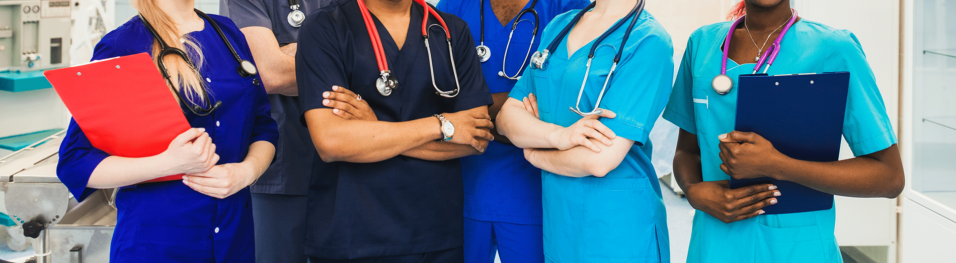 Medical professionals in scrubs pose with arms crossed, holding clipboards.