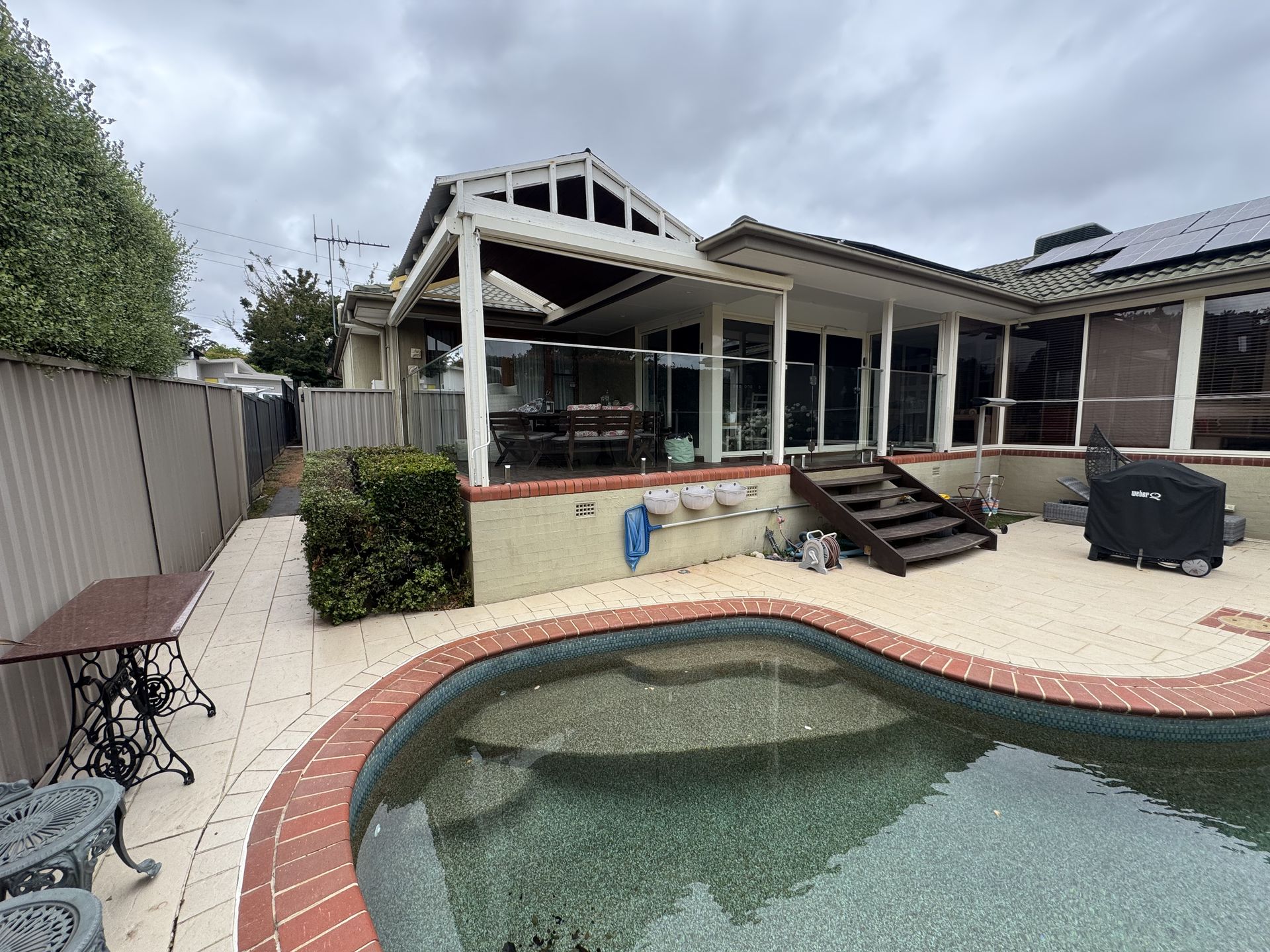 A house with a swimming pool in front of it