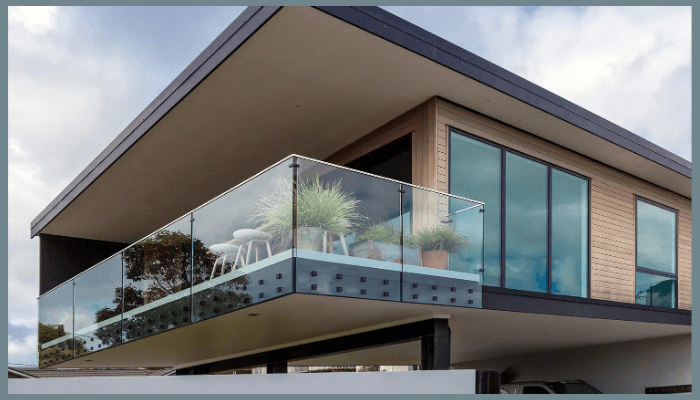 modern home with frameless glass balustrade adding style and street appeal
