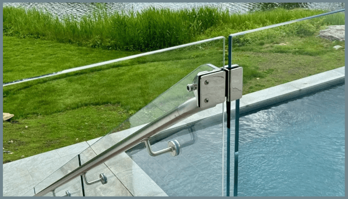 Frameless glass fence installation with stainless steel hardware near pool stairs in Canberra