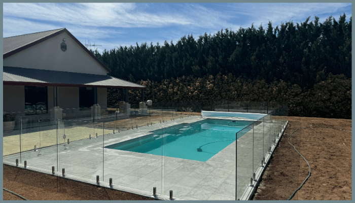 Frameless glass pool fencing around a residential backyard pool in Canberra ACT highlighting safety and modern design