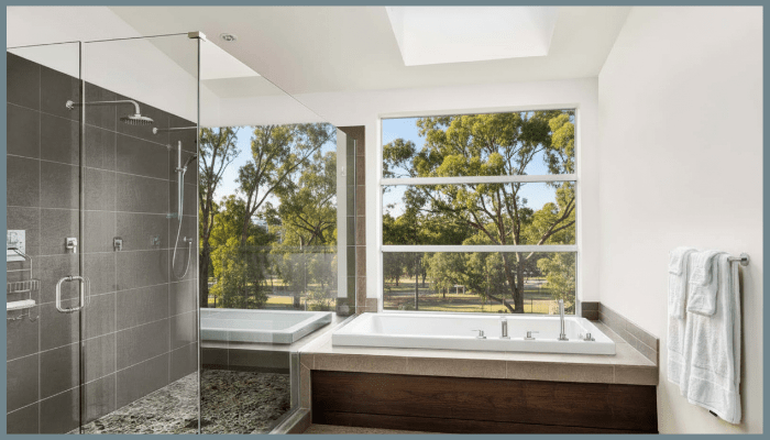 Contemporary Canberra bathroom with frameless glass shower screen and built-in bathtub overlooking garden views